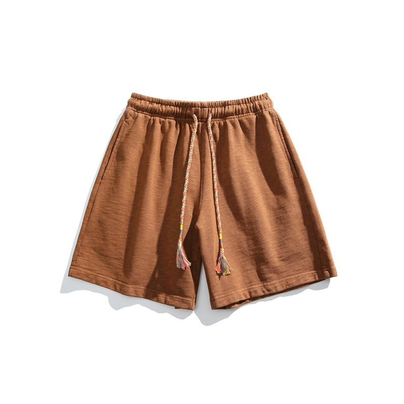 Caramel brown textured knit shorts flat lay with braided multicolor tassel drawstring