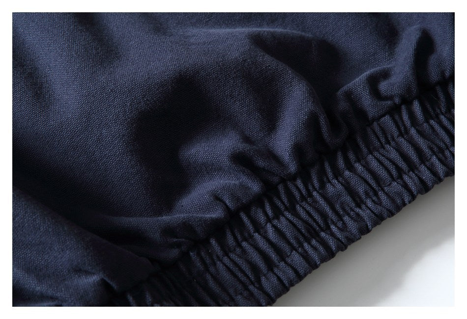 Close-up of a gathered elastic edge on dark navy fabric.