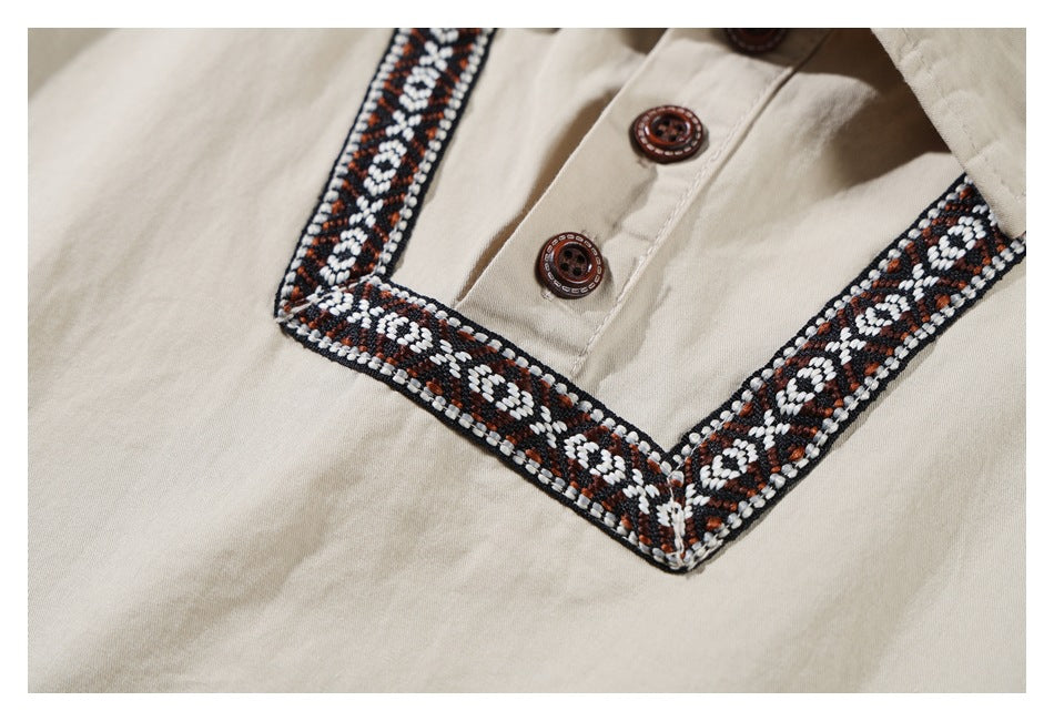 Close-up of a beige shirt's brown buttons and geometric trim around the front placket.