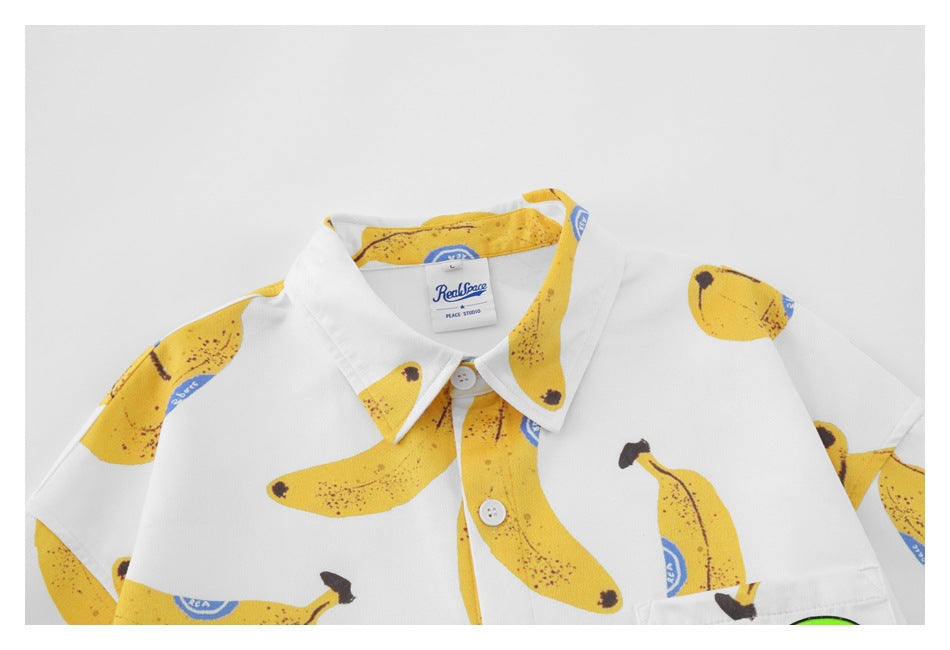 Close-up of the shirt collar, buttons and banana print, with a visible neck label.