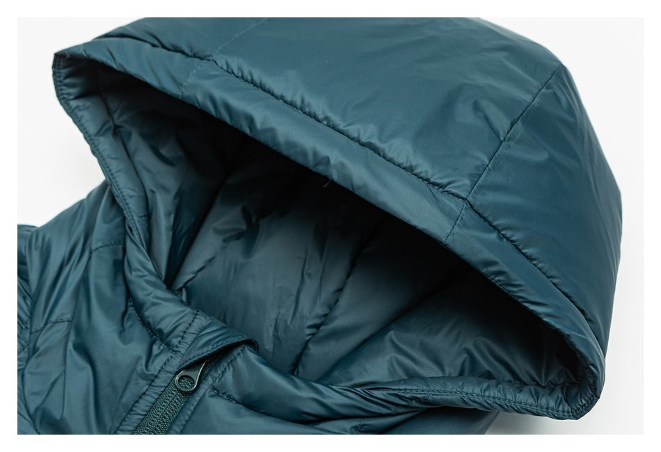 Close-up of the teal padded jacket's large hood, showing its lining and stitched seams.