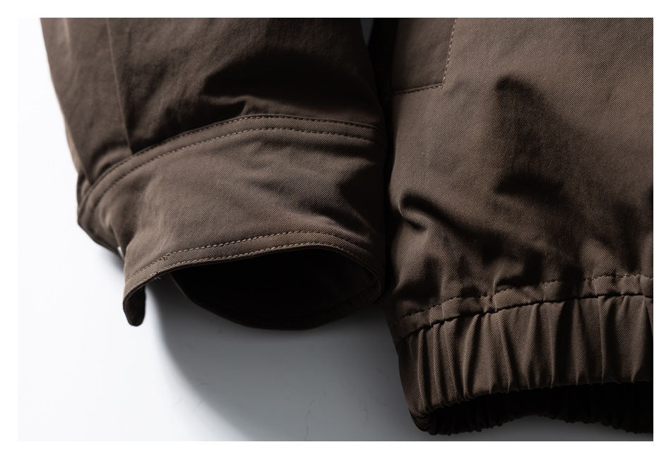 Close-up of a dark brown jacket sleeve cuff beside its gathered elastic hem.