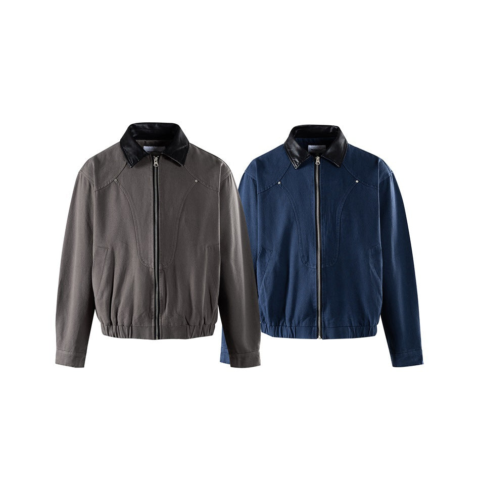Two front-view zip jackets shown side by side: one charcoal gray and one navy, both with black collars and gathered hems.