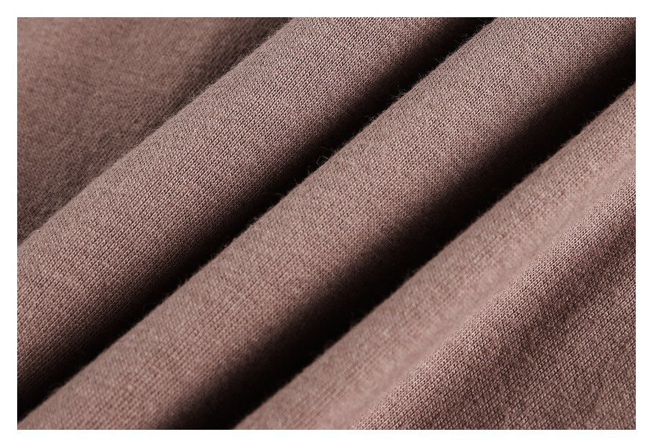 Macro view of folded brown knit fabric showing its surface texture.