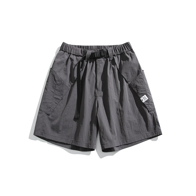 Gray knee-length shorts with elastic waist, black buckle belt and large side patch pockets, flat lay
