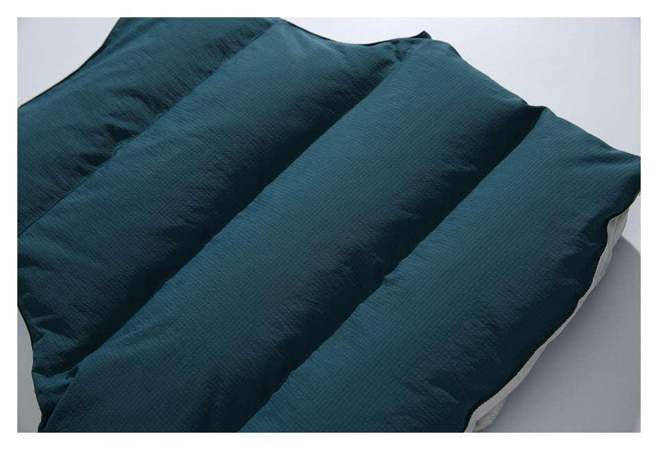 Close-up of broad padded channels in dark teal, subtly grid-textured fabric.