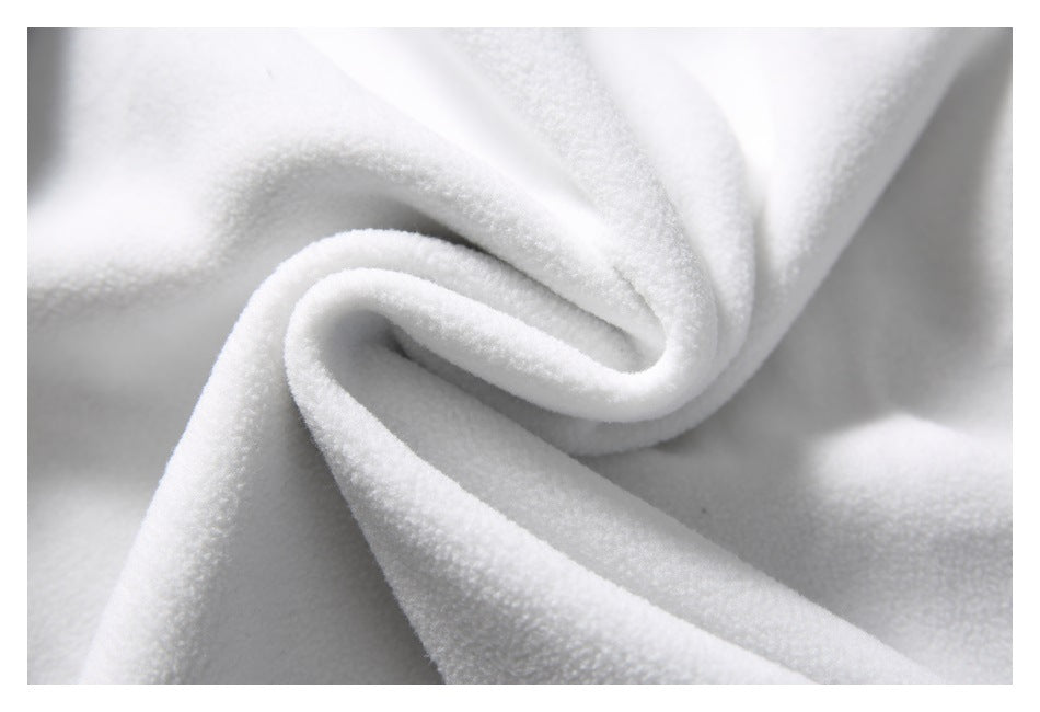 Extreme close-up of soft-looking white fabric folded into a swirl.