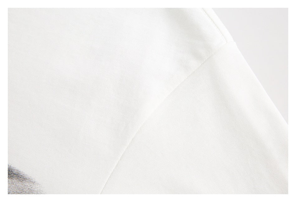Close-up of a white garment's fabric and angled seam.
