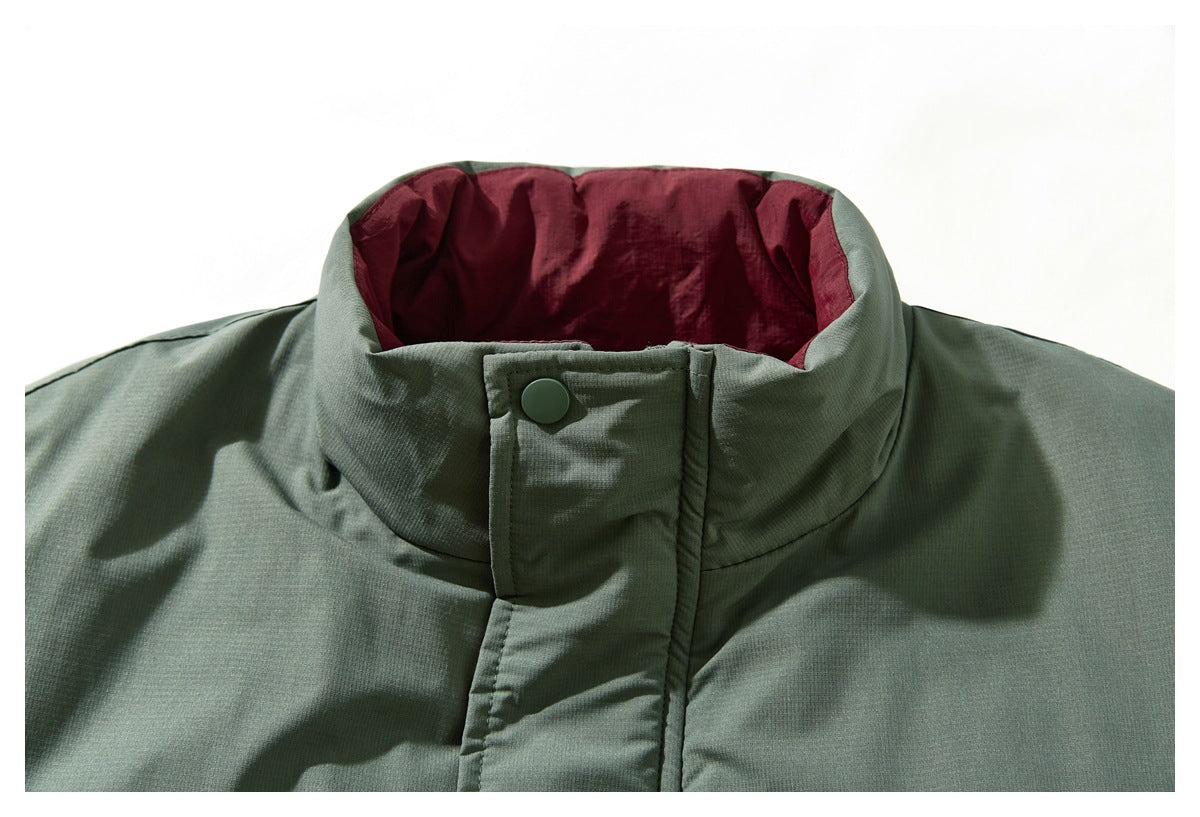 Close-up of the jacket's high sage-green collar, burgundy lining, snap, and front storm flap.