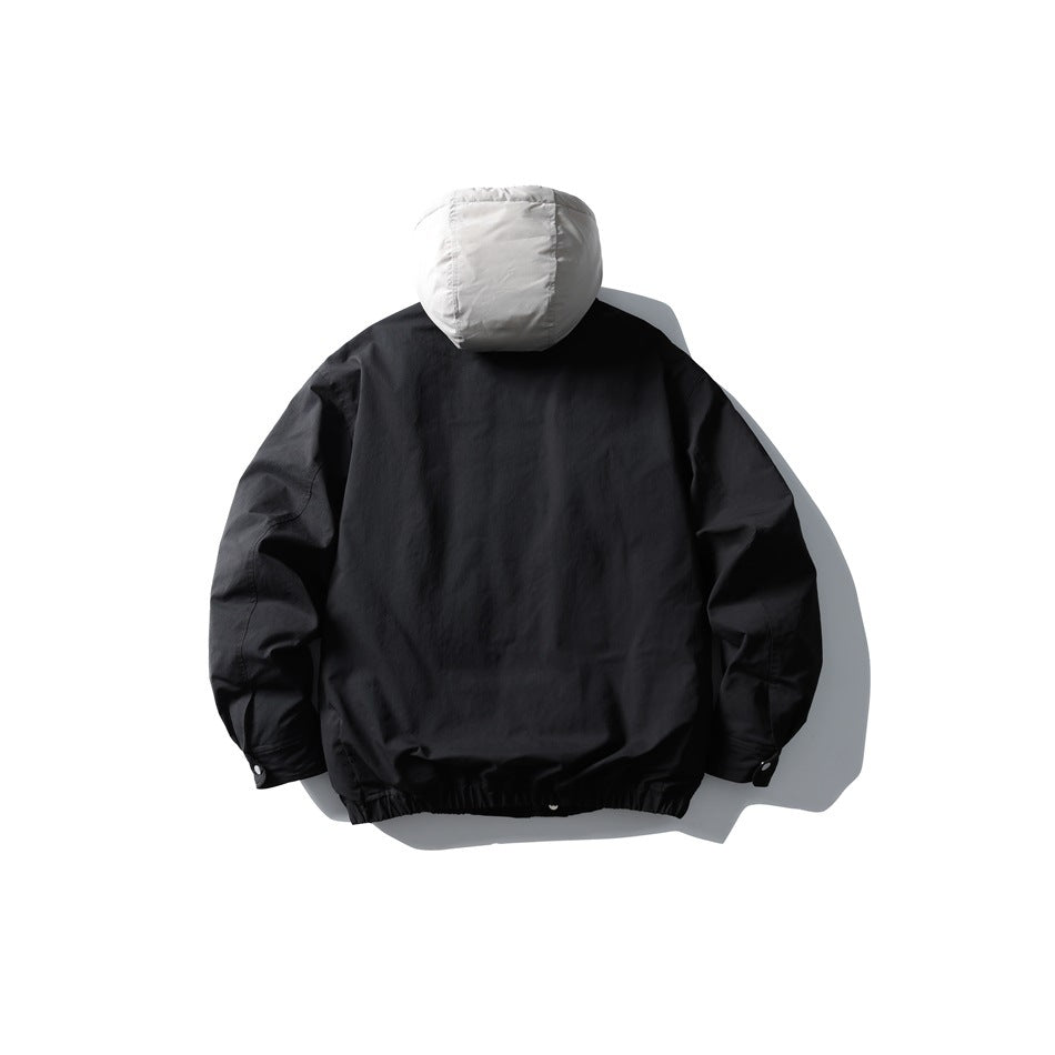 Back view of black jacket with light gray hood, elastic hem and snap cuff tabs