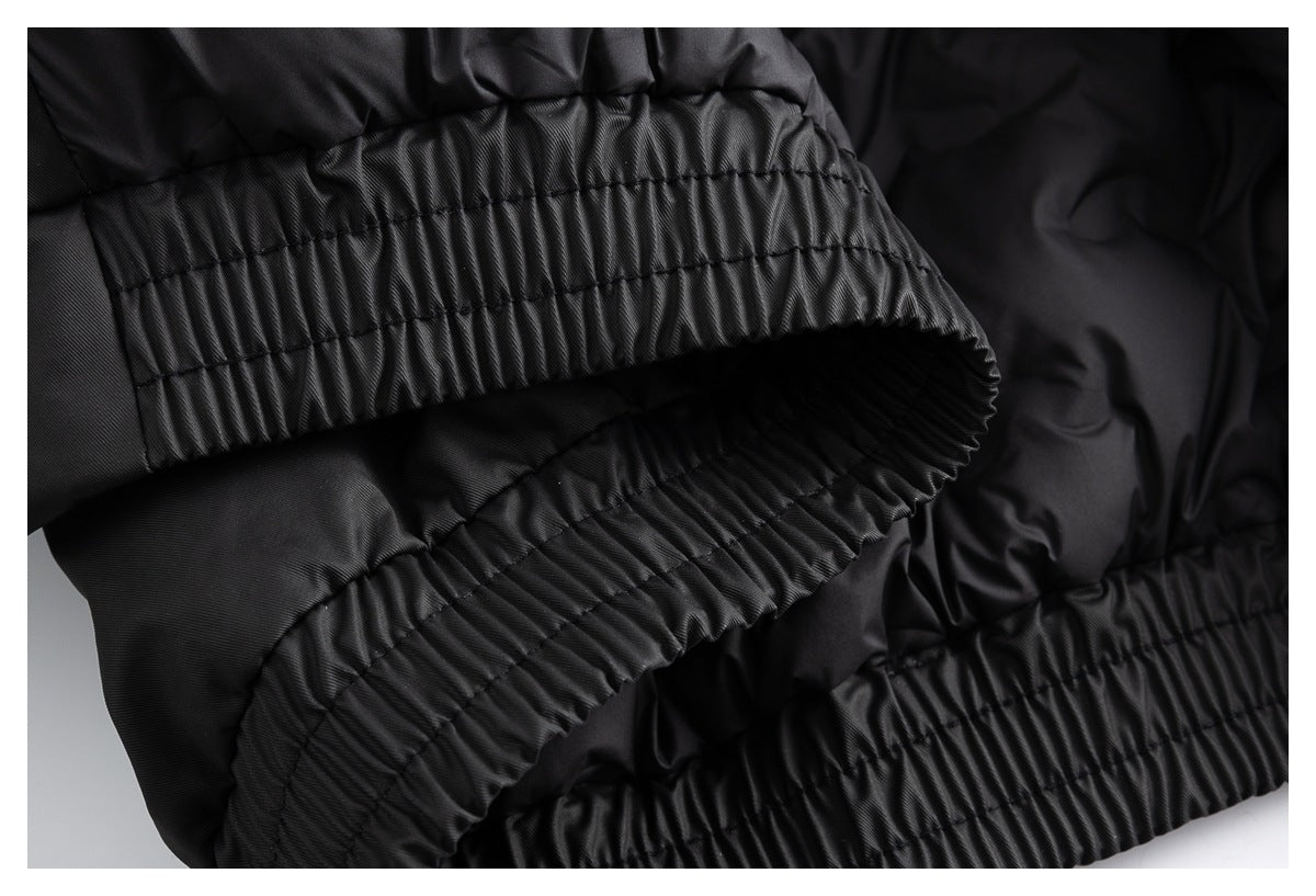 Close-up of a black garment’s gathered elastic band and stitched seams.