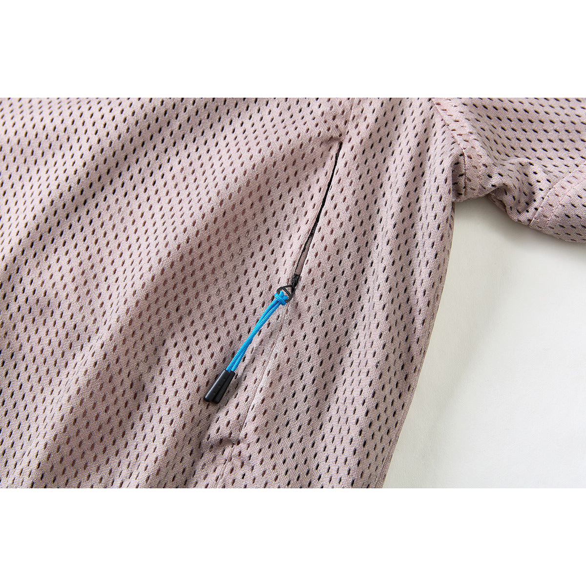 Close-up of the dusty mauve jacket front, showing a vertical pocket zipper with a blue pull cord.