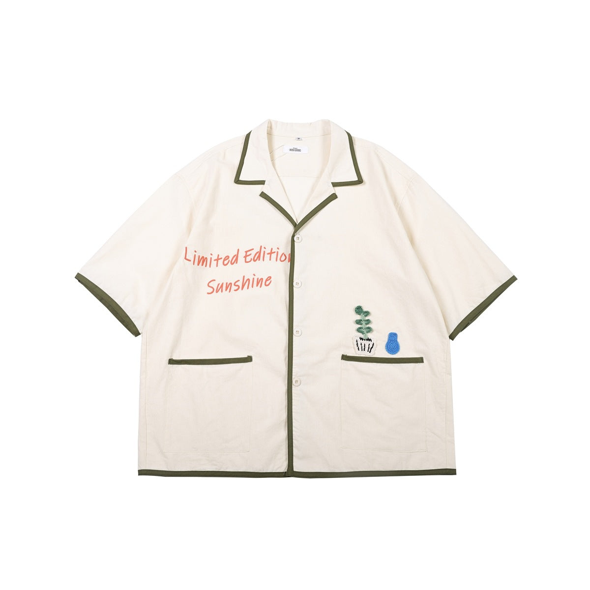 Cream short-sleeve camp-collar shirt with olive piping, pockets and Limited Edition Sunshine print, flat front view