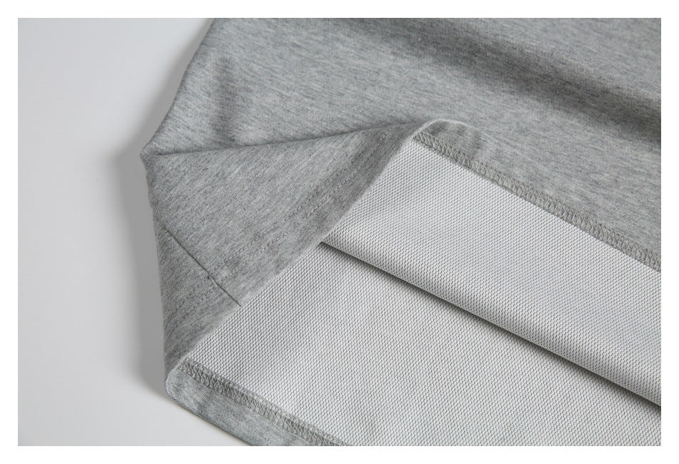 Close-up of a gray garment's folded interior hem, showing the seam stitching and inner surface.