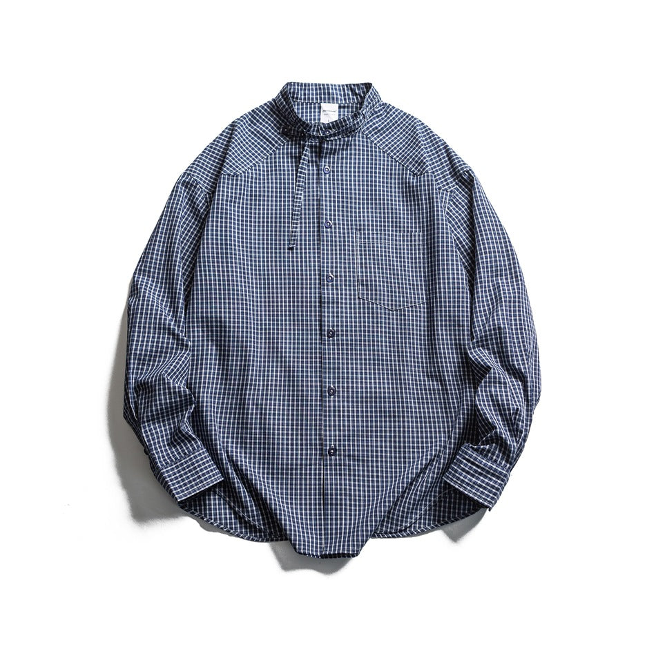 Navy and white small-check plaid long-sleeve shirt with band collar, neck strap and chest pocket, flat lay