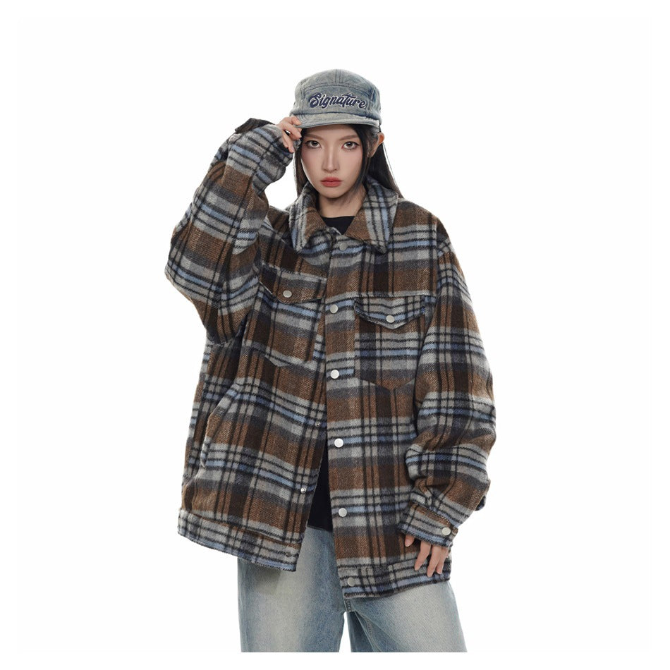 Model wearing oversized blue and brown plaid jacket with collar and snap cuffs, front view