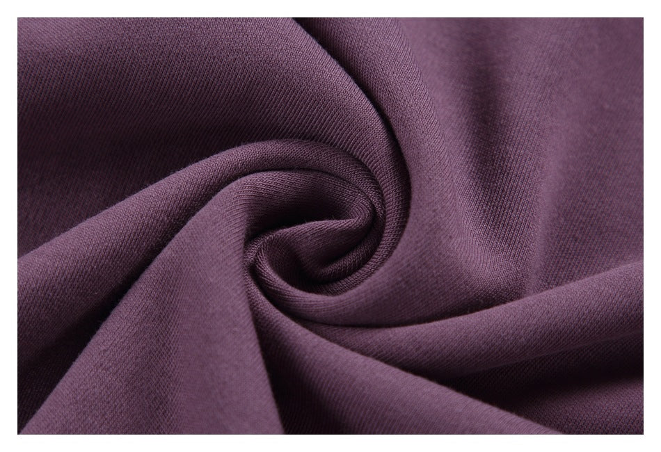 Close-up of purple knit fabric gathered into soft folds, showing its fine textured surface.