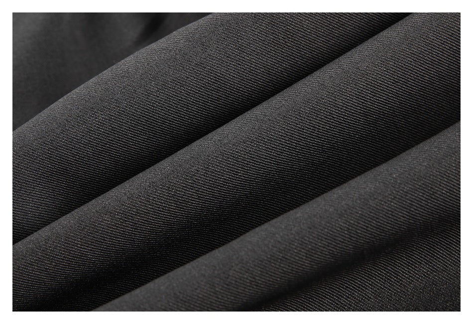 Extreme close-up of charcoal fabric showing its fine diagonal weave and folds.