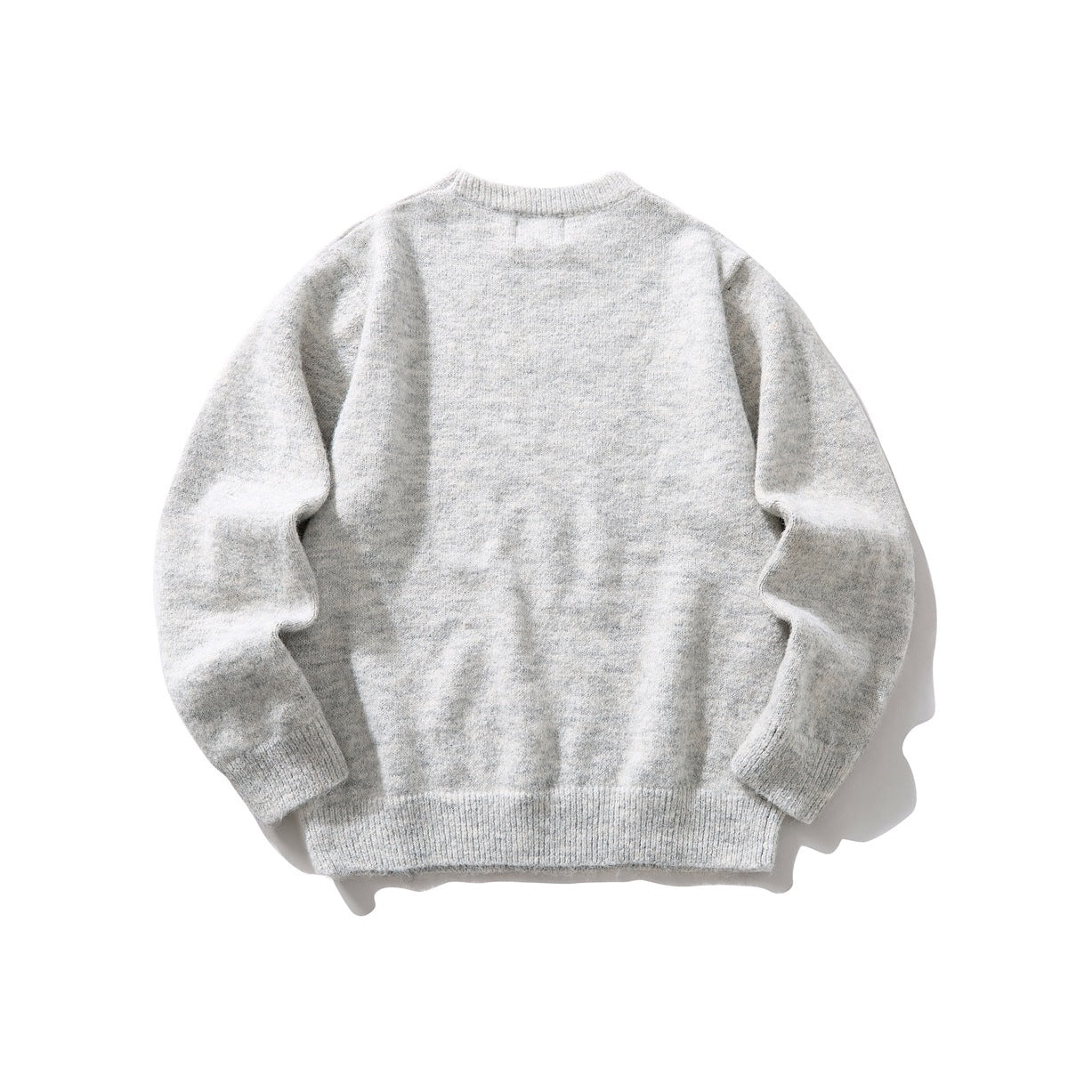 Back view of a light gray marled knit crewneck sweater with long sleeves and ribbed cuffs and hem.