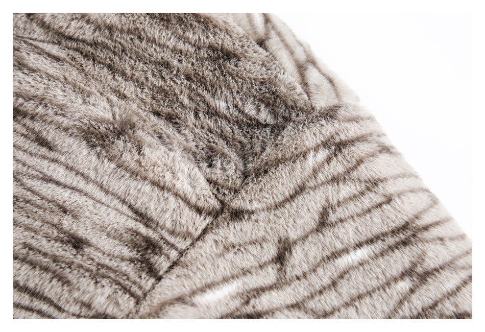 Close-up of plush gray-brown striped fur with a curved seam on the garment.