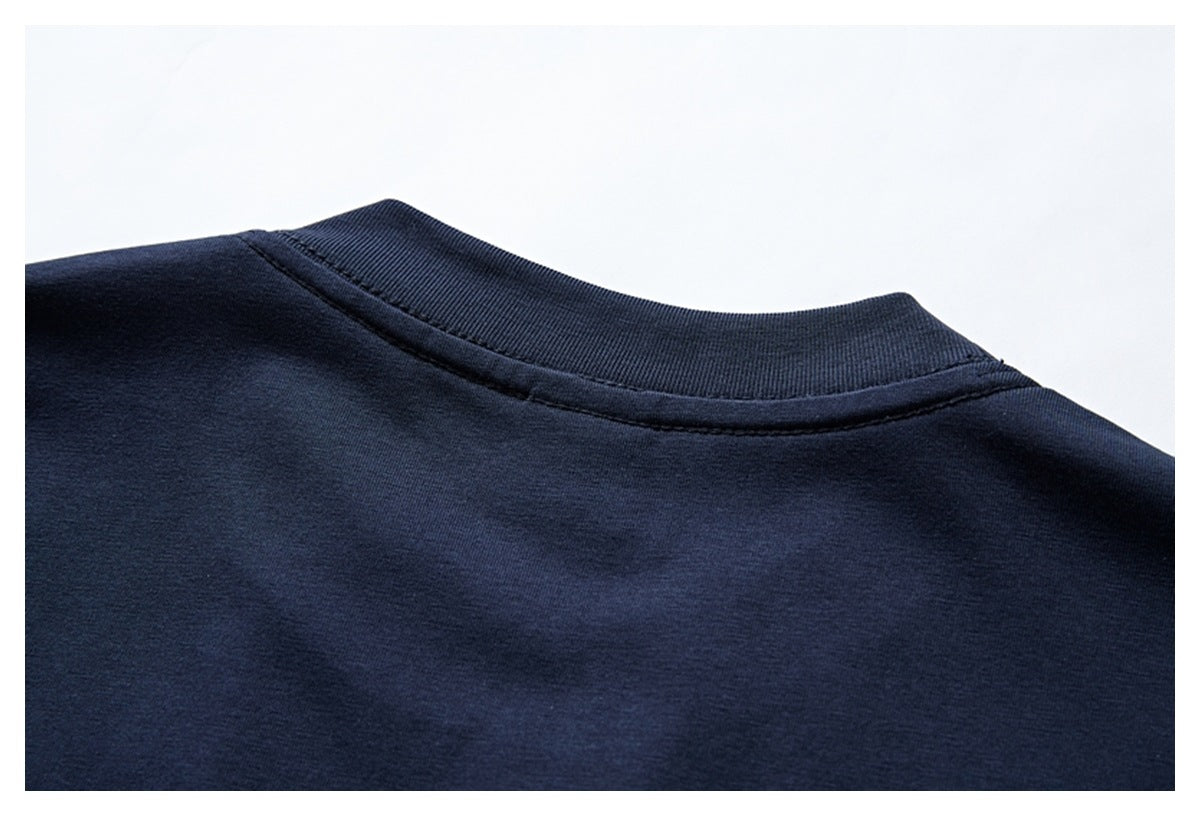 Close-up of the ribbed crew neckline and shoulder seam on a plain navy garment.
