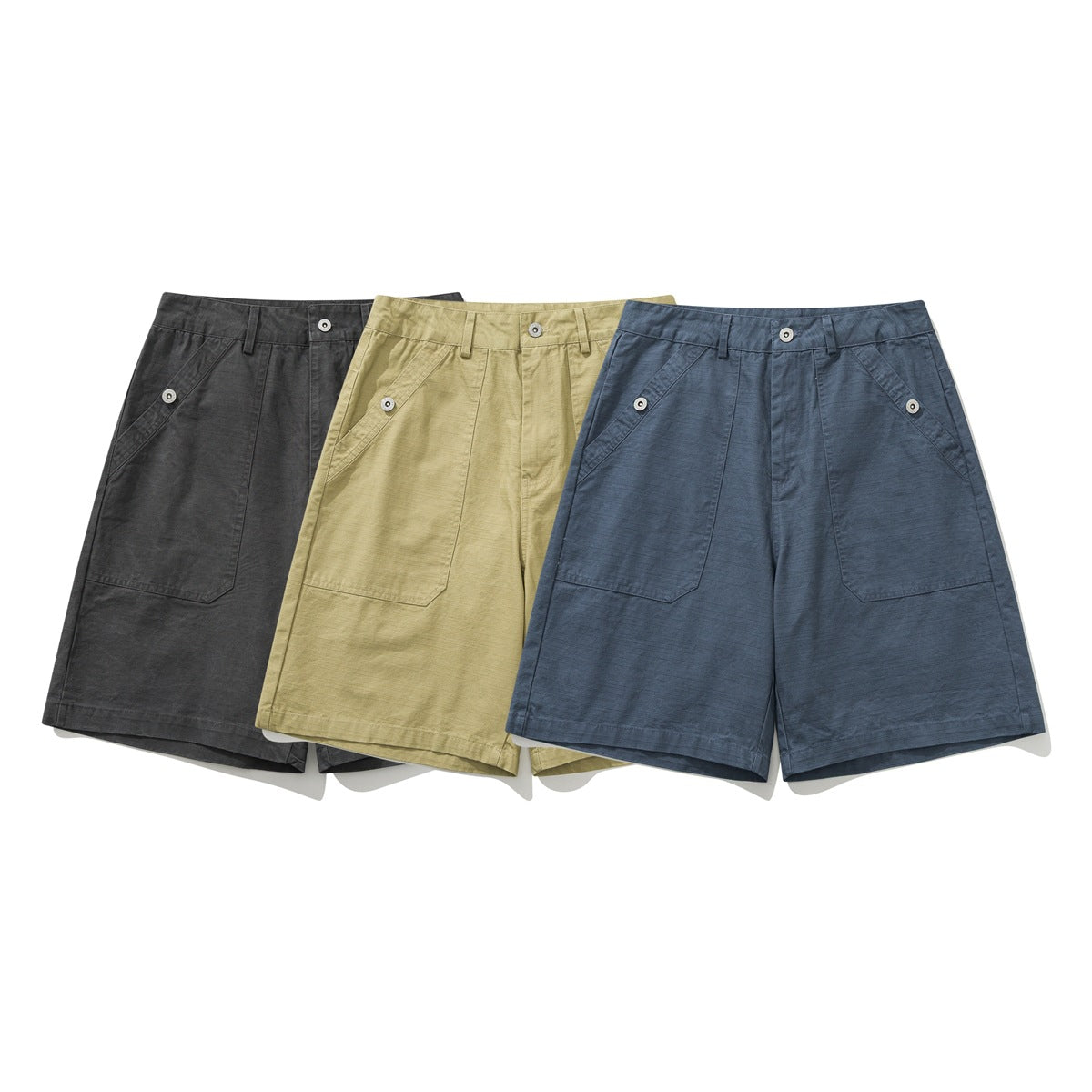 Three pairs of shorts shown from the front in charcoal, khaki and slate blue, with buttoned angled pockets.