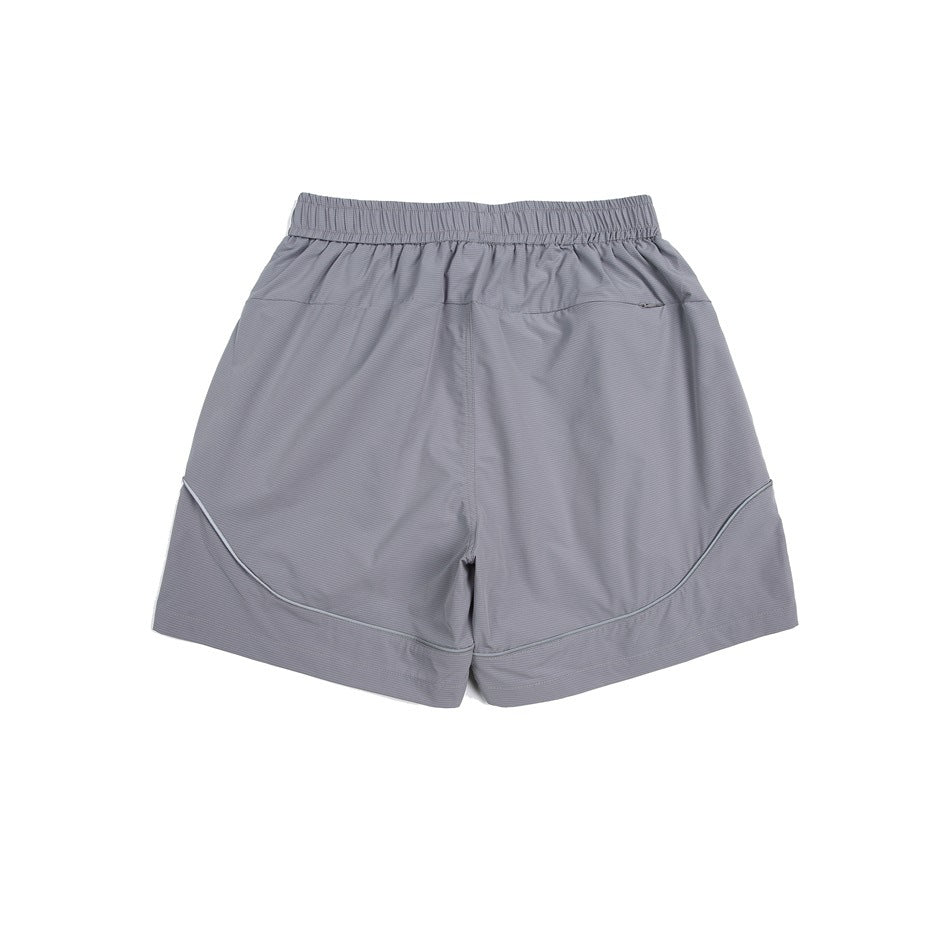 Light gray athletic shorts, back view, with an elastic waistband, small zip pocket, and curved piping.