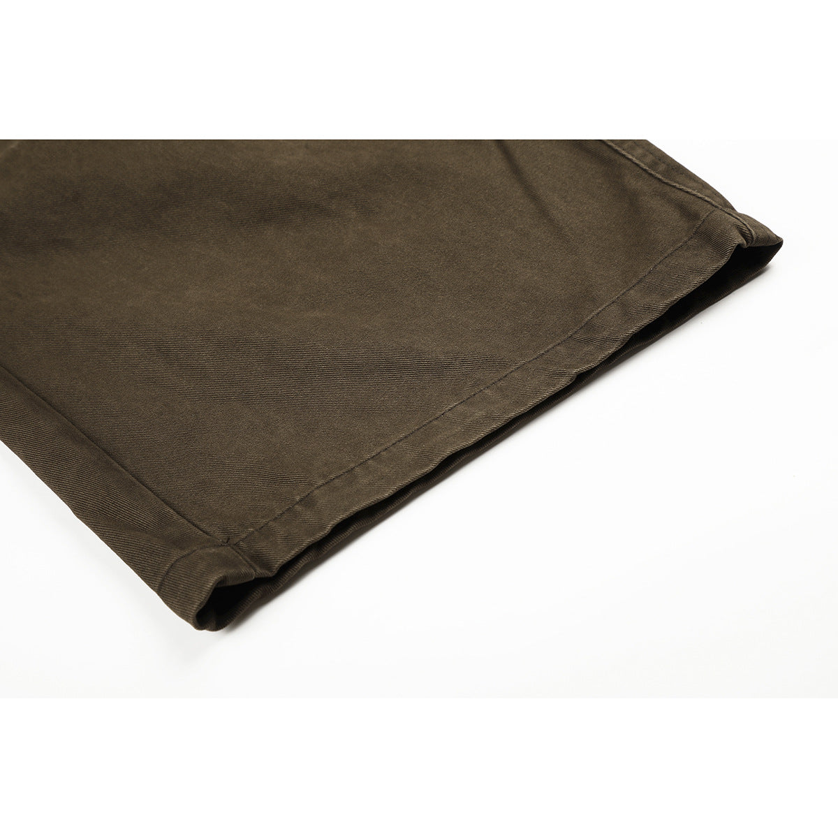 Close-up of the stitched hem on olive-brown wide-leg trousers.
