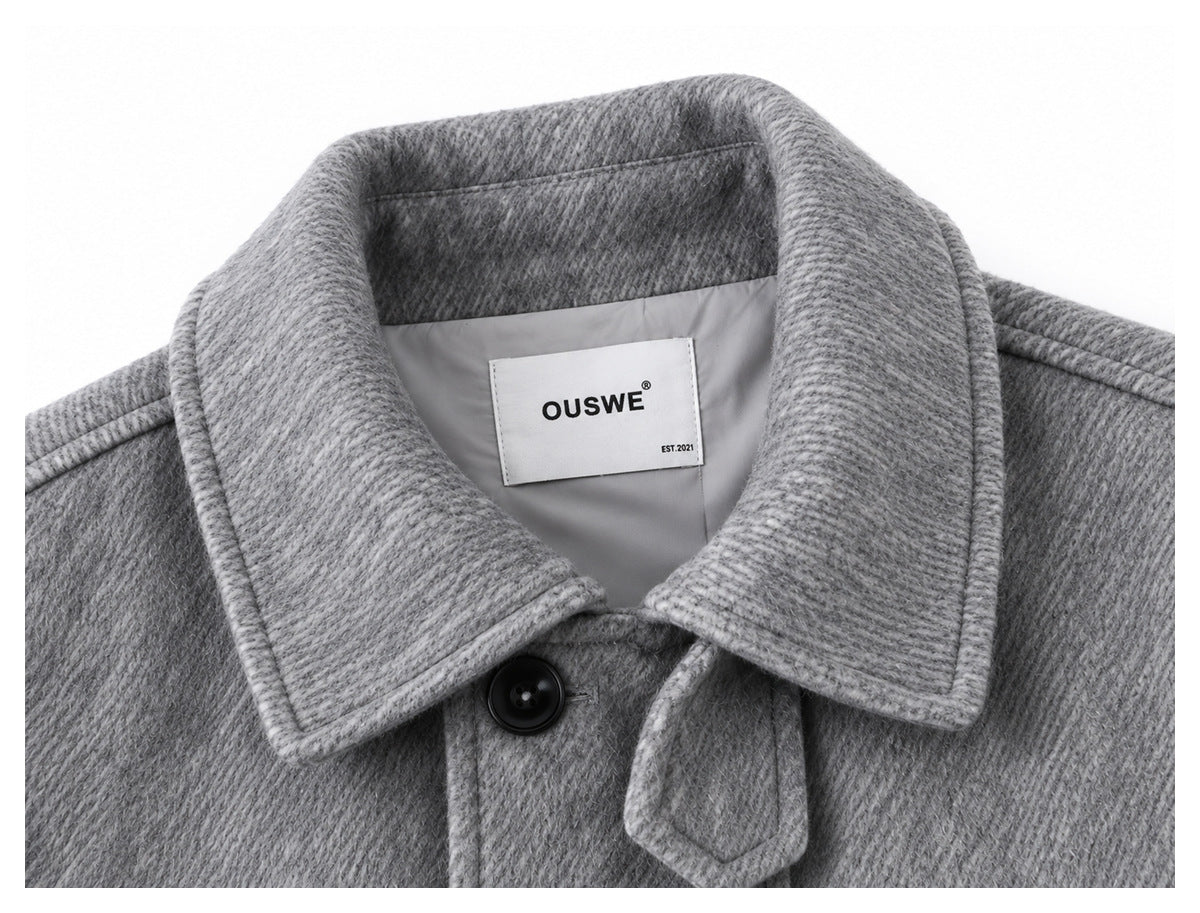 Close-up of the gray jacket collar, front button and sewn-in OUSWE label.