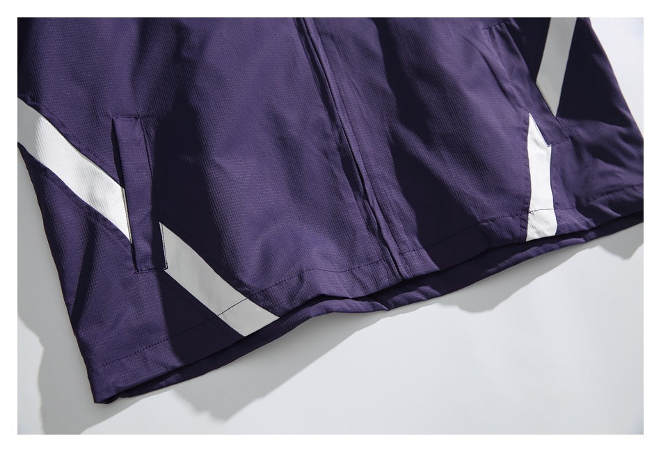 Close-up of the purple jacket's lower front, showing pockets, zipper, and white side panels.