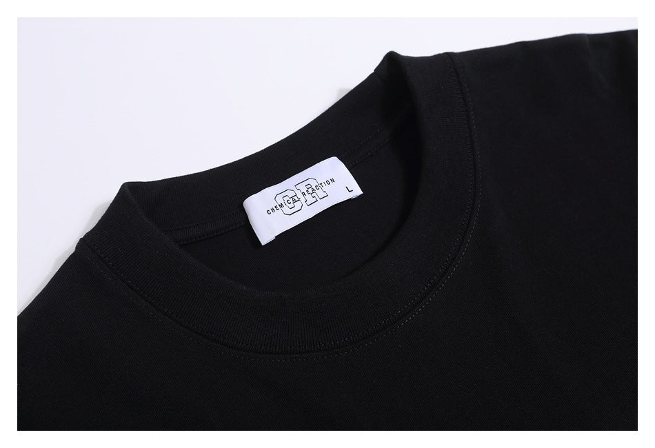 Close-up of the black T-shirt's crew neck, stitching, and inner label.