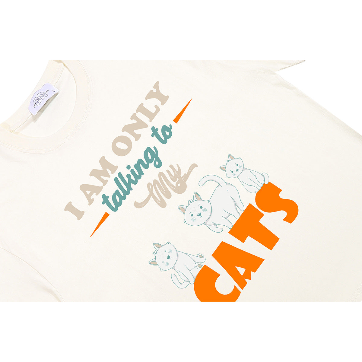 Close-up of an ivory T-shirt with a colorful cat illustration and English lettering.