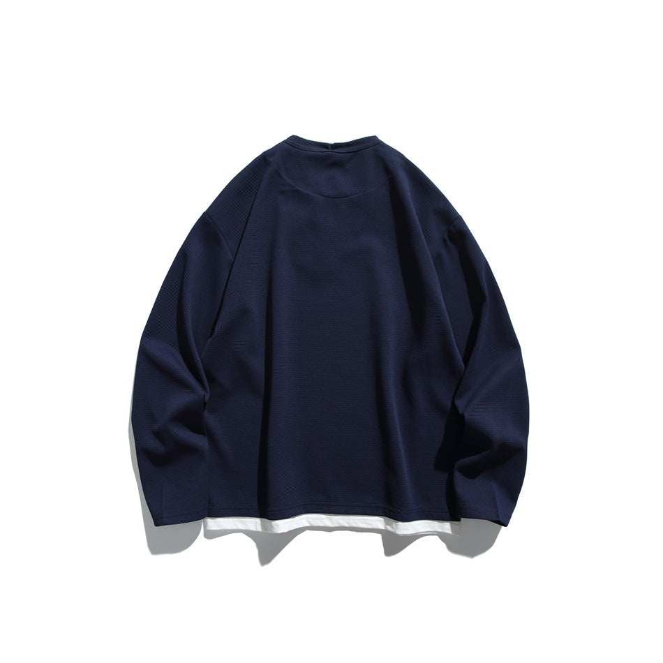 Navy blue long-sleeve pullover back view with white layered hem, flat lay