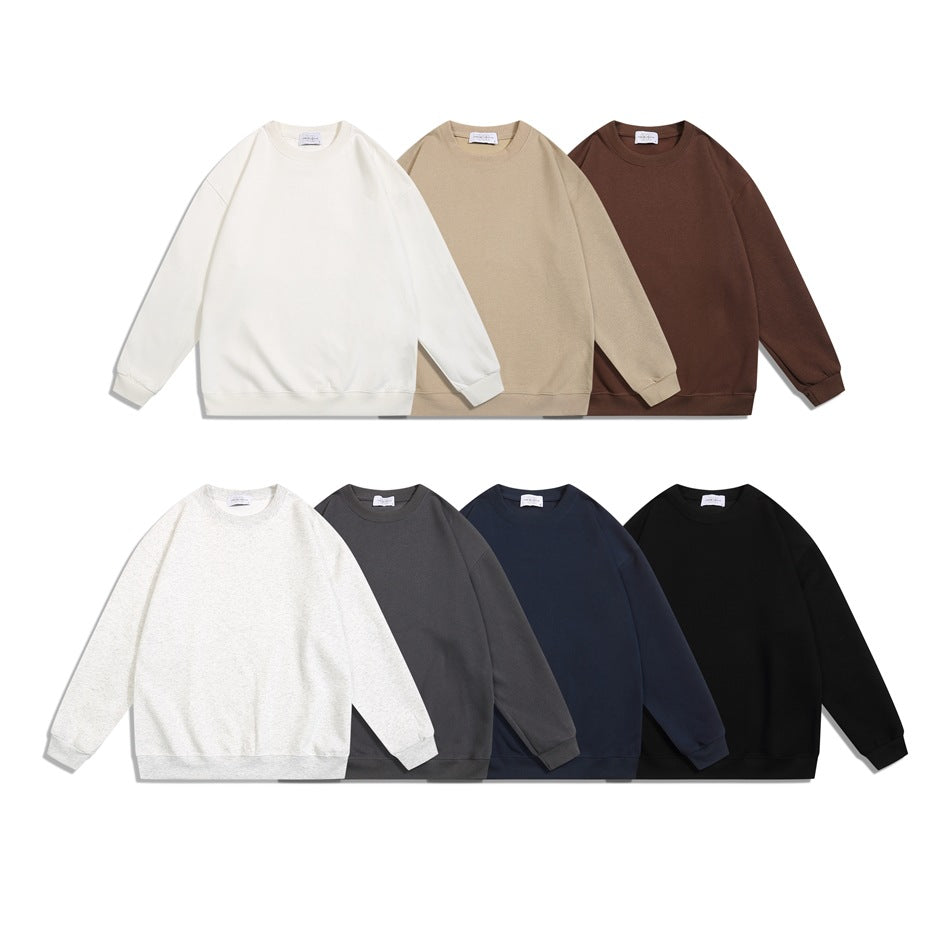 Seven plain crewneck sweatshirts shown from the front in cream, tan, brown, heather gray, charcoal, navy, and black.