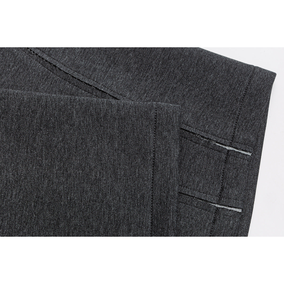 Close-up of charcoal shorts showing hem stitching and a narrow contrast detail near the edge.
