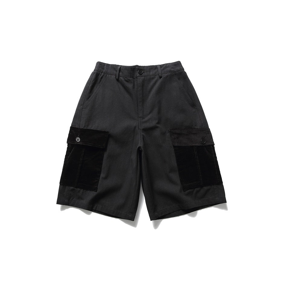 Black knee-length cargo shorts with corduroy-patched flap pockets, front view on a white background