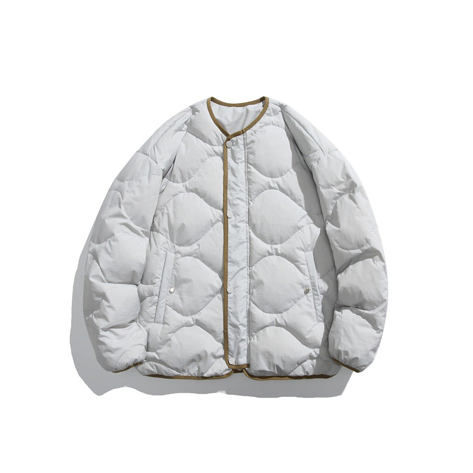 Light gray quilted collarless jacket with tan trim and snap front, flat view