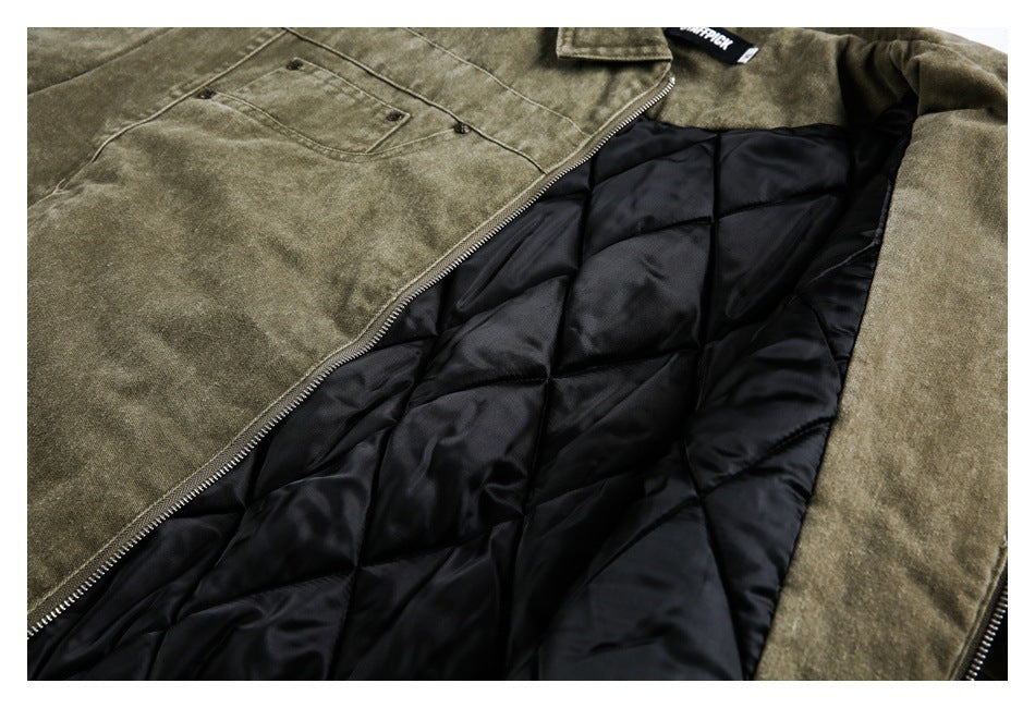 Olive-brown jacket opened to show black quilted lining, a metal zipper and a chest pocket.