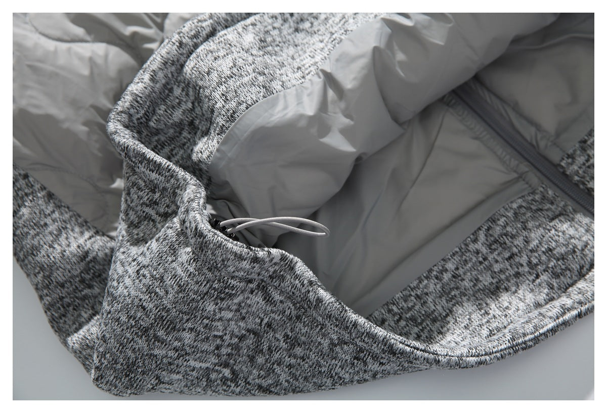 Close-up of the garment's gray lining, zipper, and drawcord against gray-and-black marled fabric.