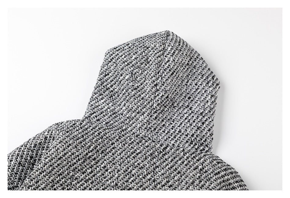 Close-up of the hood and shoulders of a black-and-white patterned jacket.