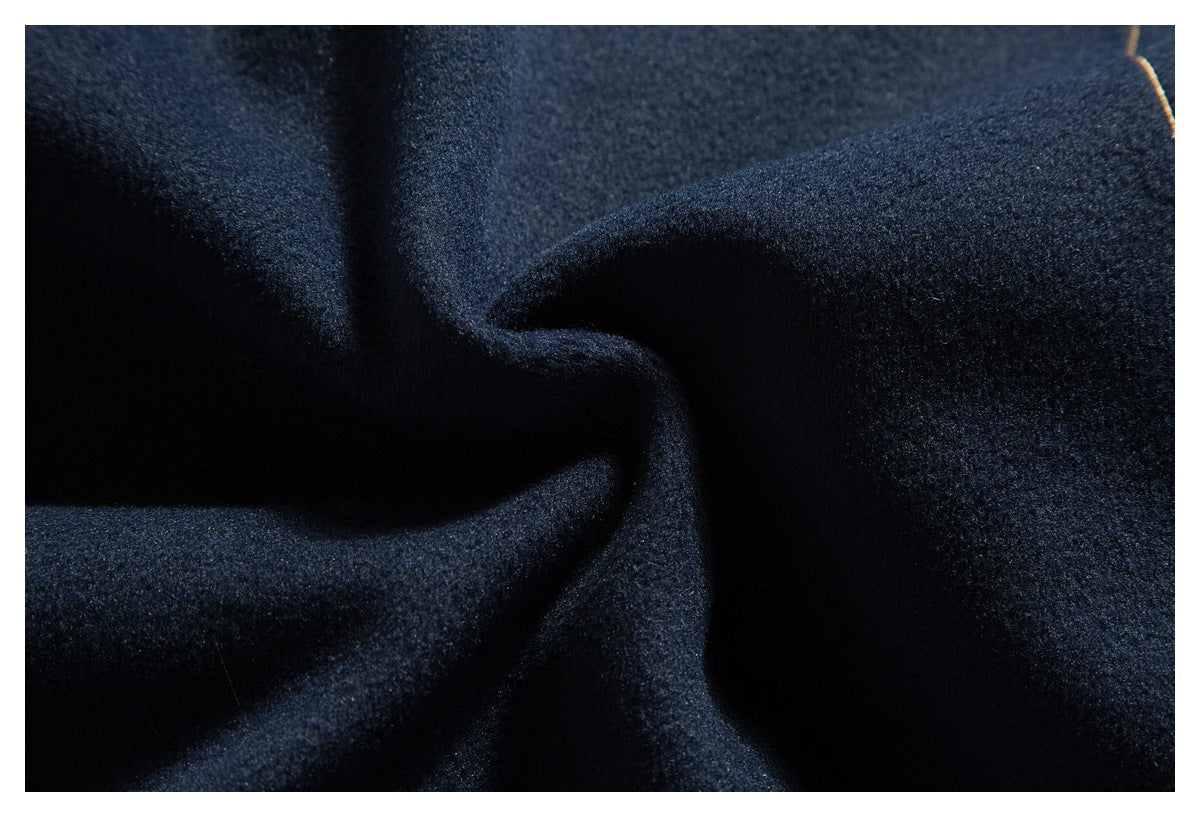 Extreme close-up of dark navy fabric arranged in soft folds.