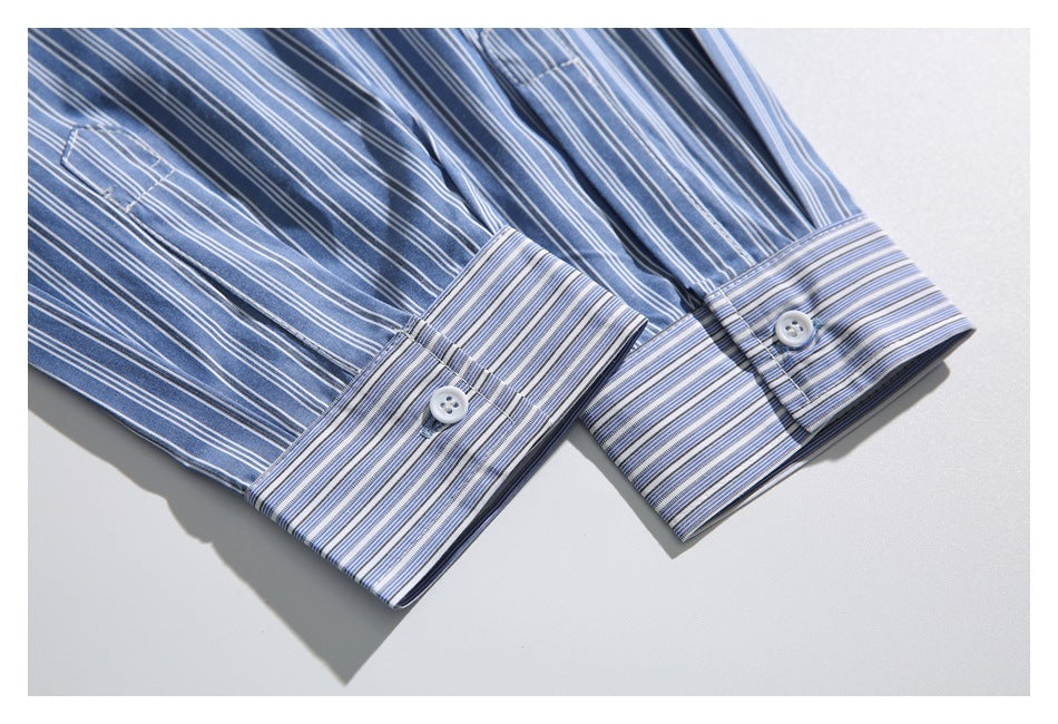 Two buttoned cuffs on a blue-and-white striped shirt, shown close up.