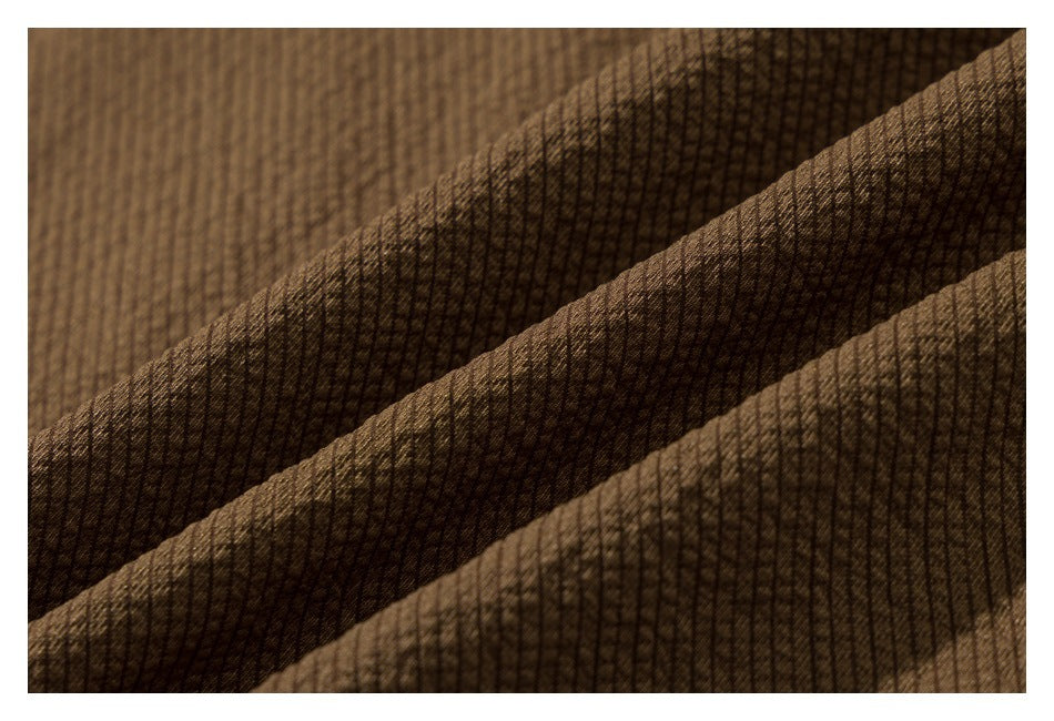 Close-up of brown ribbed fabric with diagonal folds.