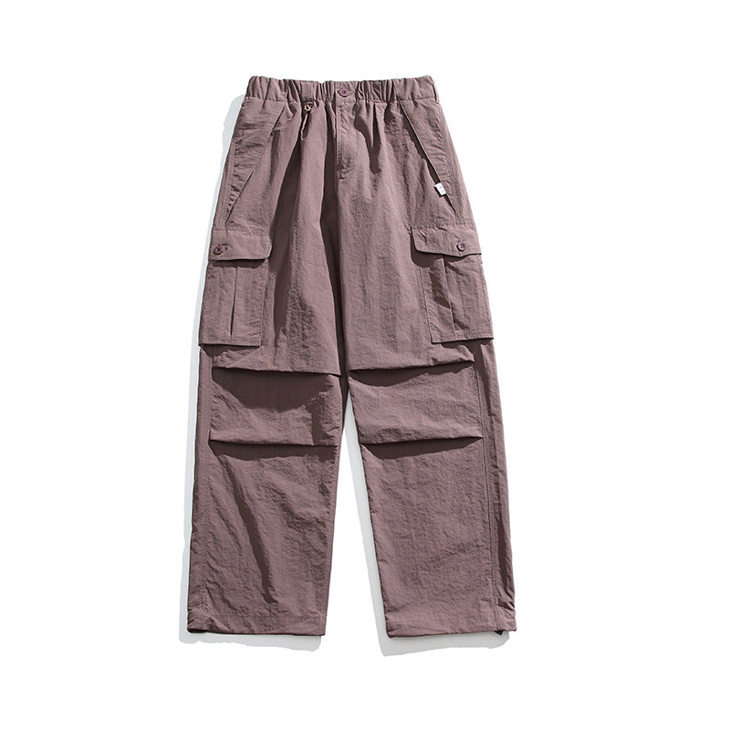 Dusty purple wide-leg cargo pants flat lay, front view, with elastic waist and button-flap side pockets