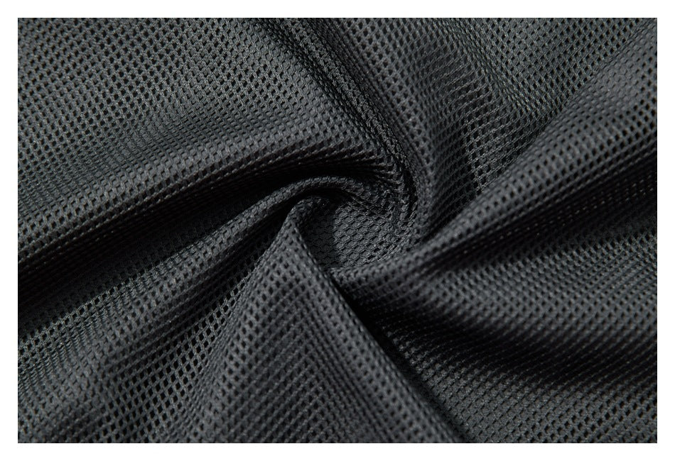 Close-up of dark mesh lining fabric gathered into folds.