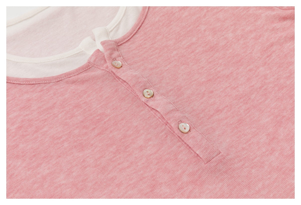 Close-up of the heather-pink top’s button placket and white inner neckline.