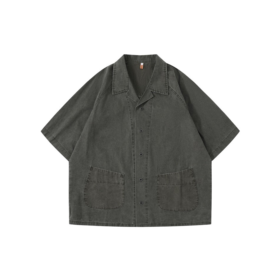 Dark gray washed short-sleeve button-front shirt with notched collar and two patch pockets, flat lay front view