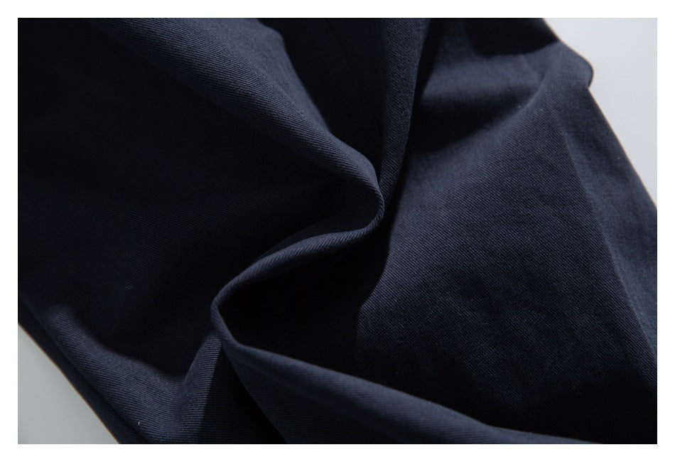 Close-up of dark navy fabric draped into folds, showing its surface and texture.