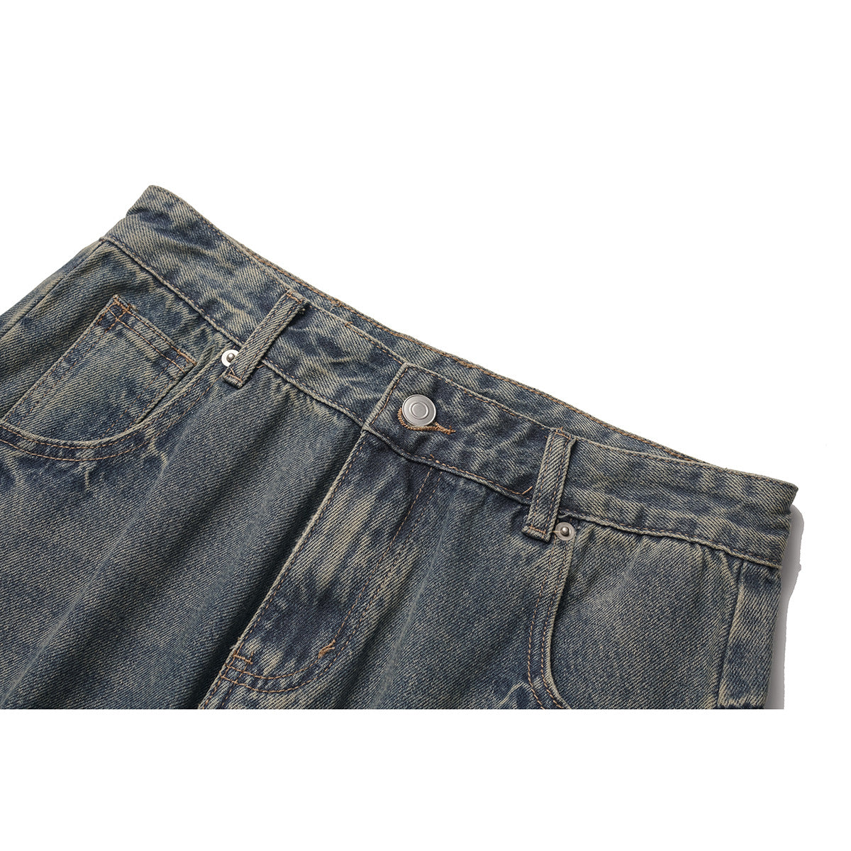 Close-up of the front waistband, button, belt loops and pocket on faded dark blue jeans.