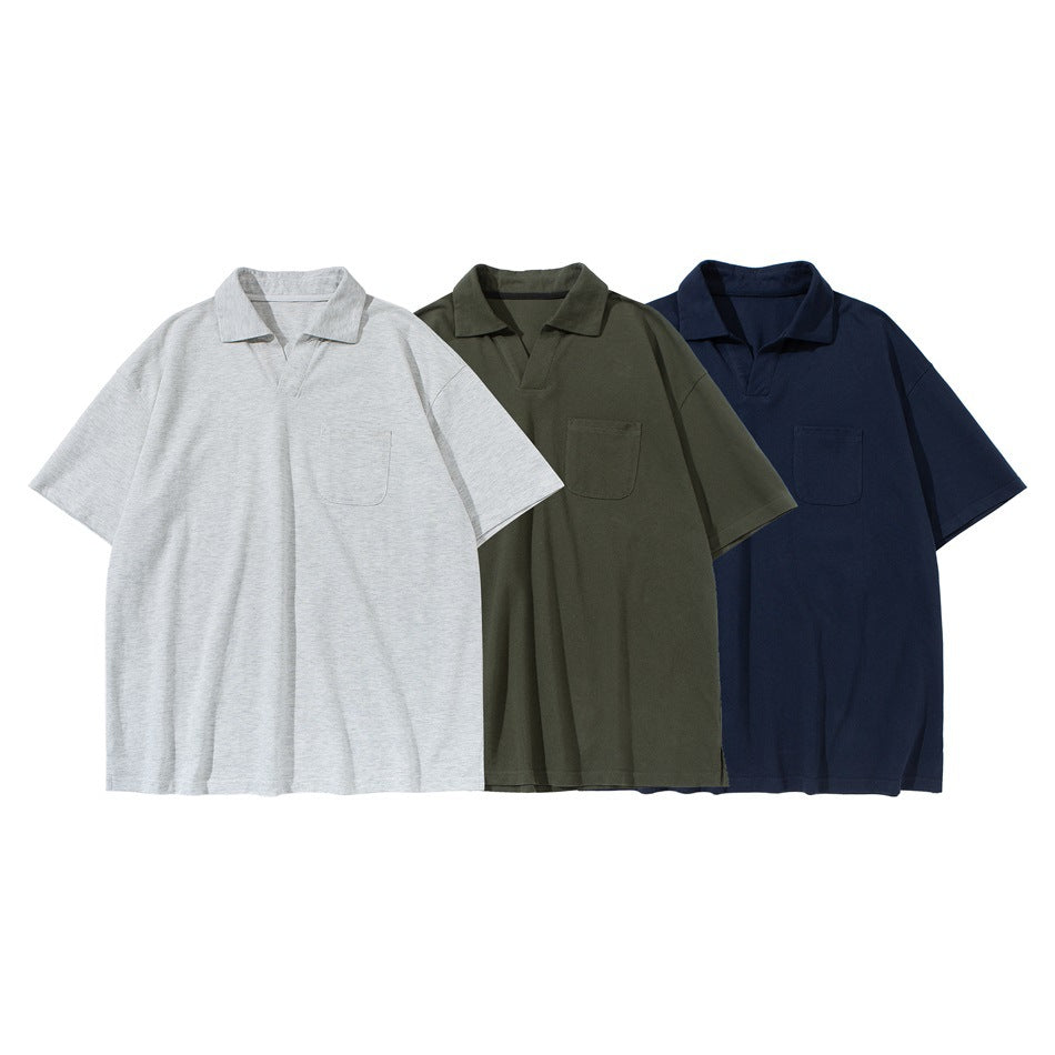 Three short-sleeve polo shirts with chest pockets shown together in light gray, olive green, and navy.
